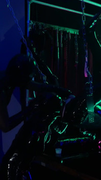 The rubber Domme the giant dildo and the gimp