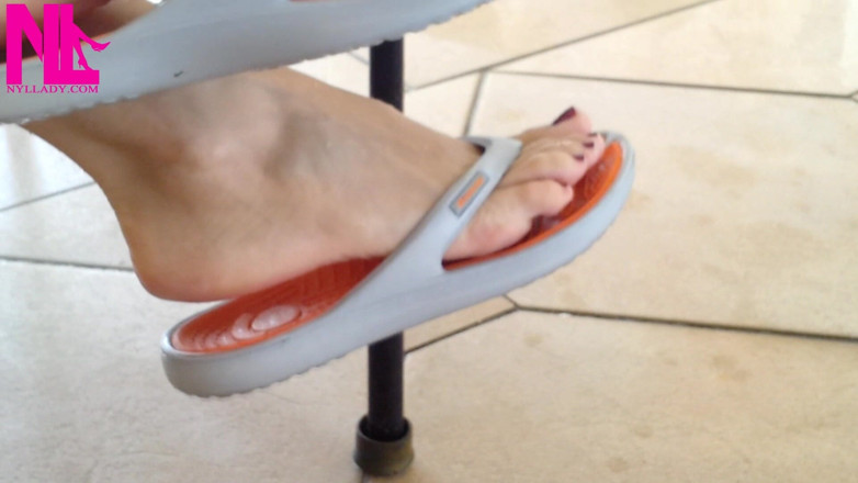 Nyllady: Dangling with Orange Flip Flops in a Swimming Pool