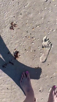 Comparing Size 16 Feet to Sand Prints at the Beach