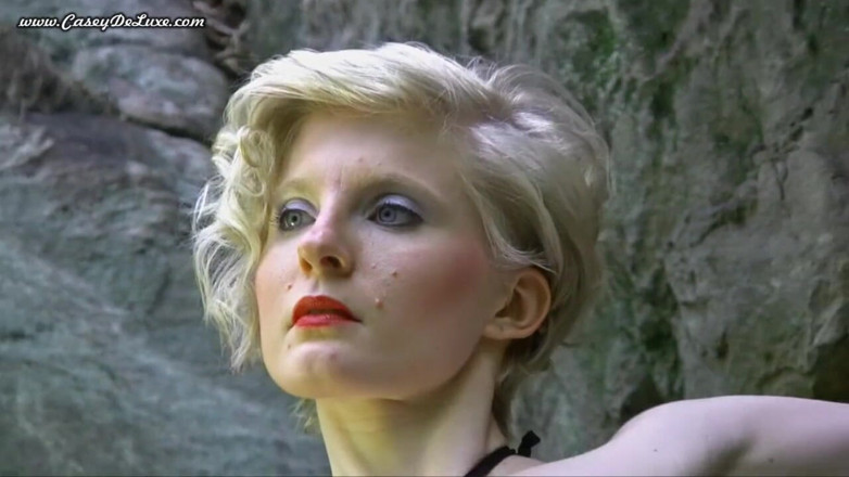 Casey Deluxe: Busty blonde posing naked at the rocks