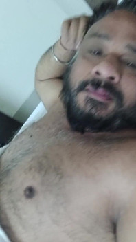 Indian Daddy Lying on the Bed Teasing and Posing for You