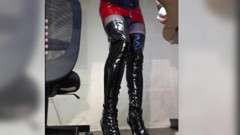 Crossdresser Getting Dressed with Boots, Fishnet, Red Pvc Dress and Corset thumbnail