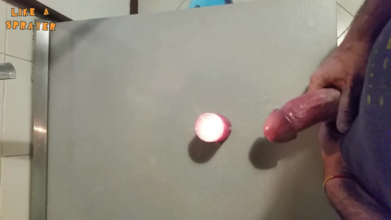 Like a sprayer: Candle cumshot by handjob