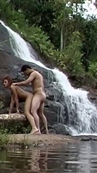 Curly Redhead MILF Rides Her Man at Waterfall