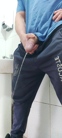 A Well-endowed Brazilian Man Urinating and Showing His Thick Penis to His Female Friends.