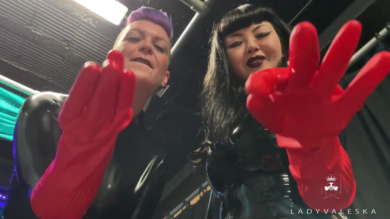 Lady Valeska: Latex Dommes invite you to suck their huge strap ons