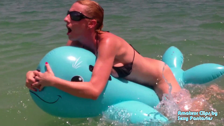 Brittany Lynn: Humping blue inflatable toy in the water at a beach...