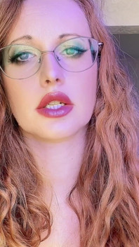 Kızıl saçlı orta yaşlı seksi kadın edepsizce konuşuyor ve seksi dudaklarını ve azgın yüzünü azdırıyor