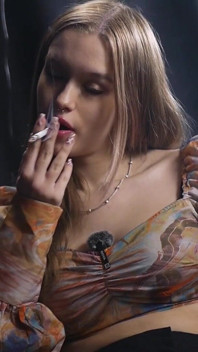 Sweet Russian Blonde Smoking in Colorful Blouse