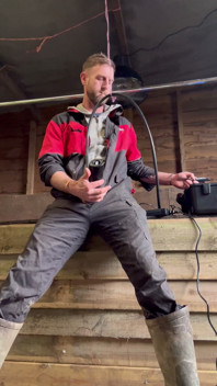 Agricultor fuma e se ordenha com a máquina de ordenha