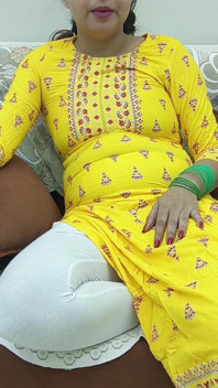 Indiancă desi femeie într-un sari pe o canapea care își expune sânii