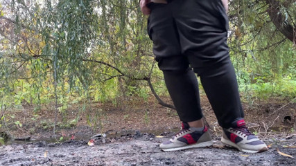 Elena: MILF dressed in pants pissing outdoors