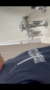 Pissing at a urinal with no dividers.