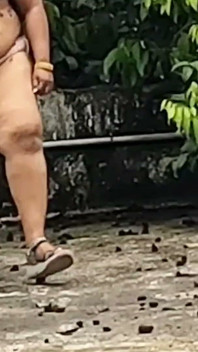 A Full-figured Woman in a White Skirt and Pink Top Strips Down and Walks Nude Outside