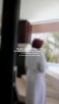 Woman Hijab Bathing Naked in an Open-air Hotel Pool