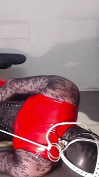 Hogtied in Boots, Fishnet, Red Pvc Suit and Masked. Struggling to Get Free.