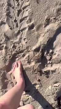 Comparing Size 16 Feet to Sand Prints at the Beach