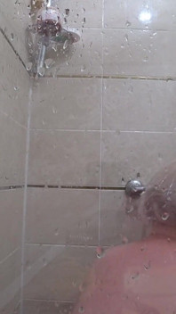 The camera is watching a mature chubby milf in the shower. Gorgeous fat ass, big natural boobs, hairy pussy. PAWG.
