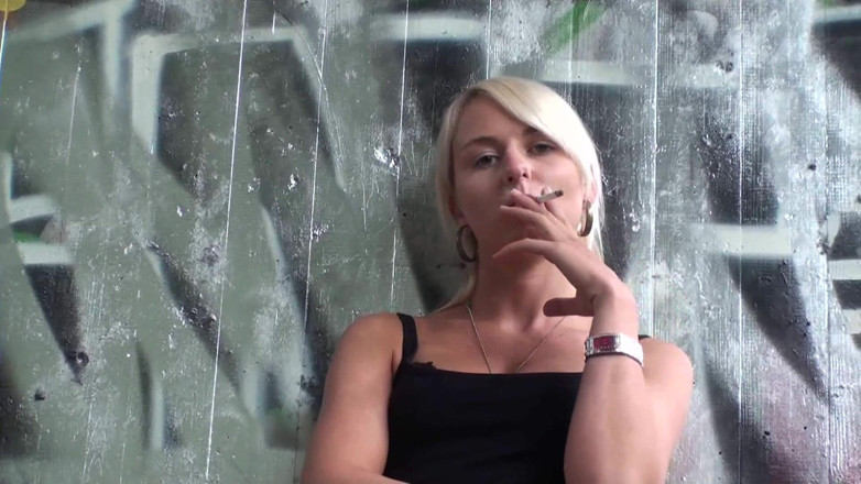 Femdom Austria: Lovely blonde teen smoking a cigarette outdoors