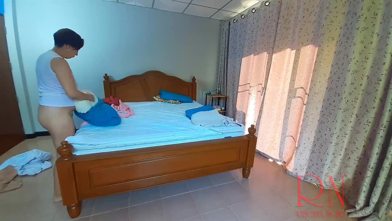 Regina Noir: Nudist housekeeper Regina Noir makes the bedding in the bedroom....