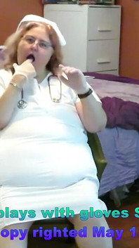 Angeforderte Krankenschwester spielt mit selbst mit medizinischen Handschuhen auf striptease!
