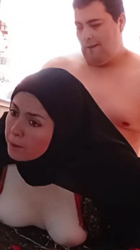 Ragazza Araba Che Scopa Con Il Velo in Cucina