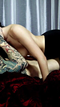 Tattooed brunette babe with nice tits is getting plowed on the bed