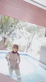 Hijab-wearing Woman Bathes Naked in an Open Swimming Pool