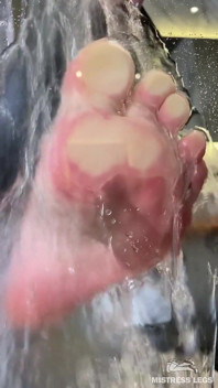 Sexy nasser nackter fuß gegen glas in der dusche gedrückt