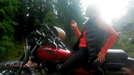 Abella Love: Red lips blonde smoking sensually on Rasta bike outdoor