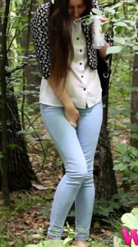 Desperate Brunette in a Forest Holding Her Crotch to Stop Herself From Pissing in Her Jeans