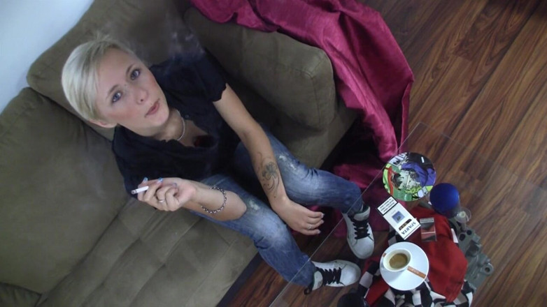 Smoke it bitch: Blonde young chick with piercing between her eyebrows smokes a...