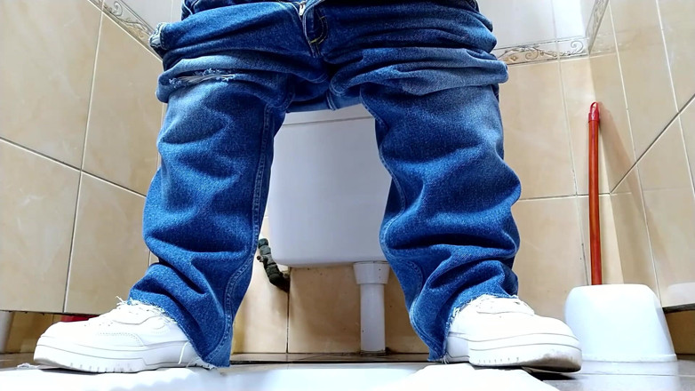 Elena: Hot MILF in jeans pissing in a public restroom