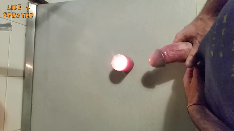 Like a sprayer: Candle cumshot by handjob
