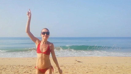 Abella Love: Slim MILF taking sun bath and peeing twice on beach