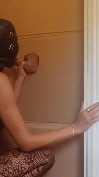 In a Nylon Catsuit and High Heels I Suck a Cock and Fuck It in a Gloryhole Until It Cums in My Mouth