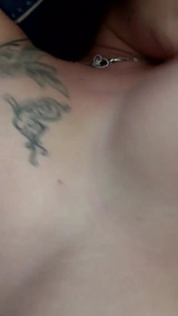 Sexy tattooed brunette sprayed on her boobs