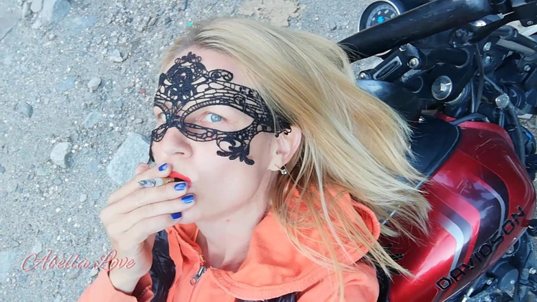 Abella Love: Red lips blonde smoking sensually on Rasta bike outdoor