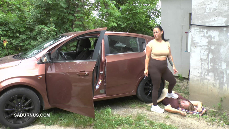 Sadurnus: Mistress Jenna Stands on the Slave with a Car While...