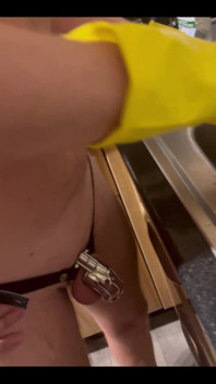 My Chastity Sub Washing the Pots for Me Naked in His Chastity Cage and with His Marigolds on