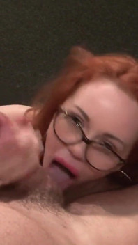 Redhead with glasses Ella Hughes sprayed on her face from Pascal White