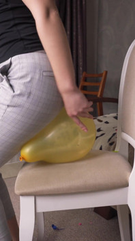 Seksowna dziewczyna wyskakuje balony w zgrane spodnie