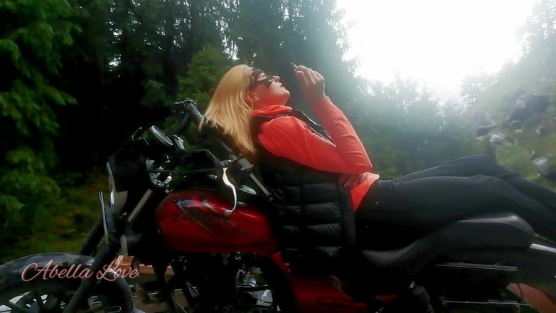 Abella Love: Red lips blonde smoking sensually on Rasta bike outdoor