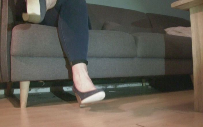 Pov legs: Bleu kot pantolonlu topuklu ayakkabılarla kanepede oturup beyaz telefon oynuyor