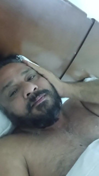 Indian Daddy Lying on the Bed Teasing and Posing for You