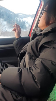 Grandi labbra che fumano in pantaloni di pelle dell'auto