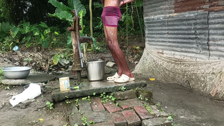 Ranjit Roy: Black mature man bath in desi style. Showing big dick.