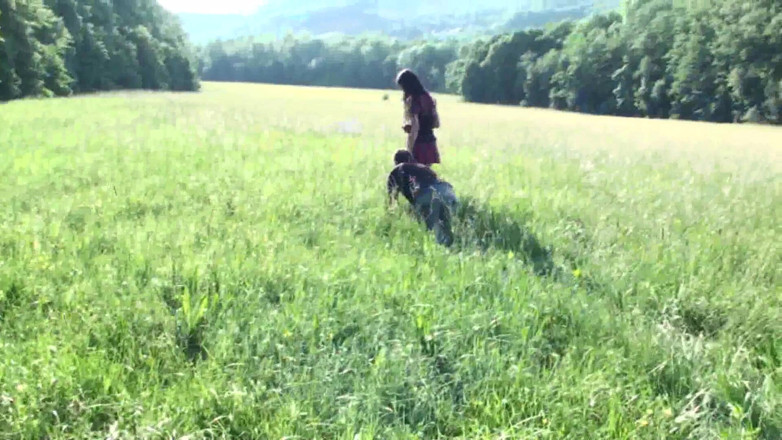 Femdom Austria: Pet on the leash in a meadow