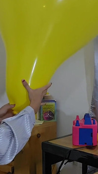 Marianna probeert haar vierkante ballon op te blazen zonder hem te barsten