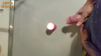 Like a sprayer: Candle cumshot by handjob
